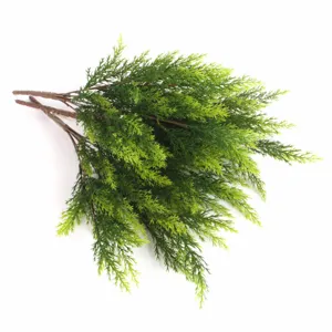 Detailed macro view of lush artificial green cedar pine branches for Christmas decor