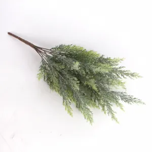Detailed close-up of realistic artificial pine needle branch for holiday decor.