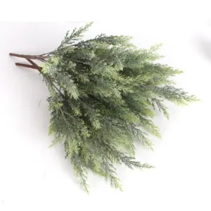 Detailed macro view of high-quality artificial green pine needle branches for decoration.