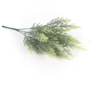 Detailed close-up of a realistic artificial green pine needle branch for holiday decor