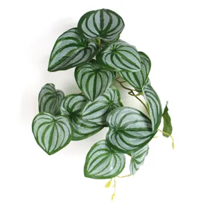 Close-up view of 3D printed artificial watermelon peperomia leaves for home decor