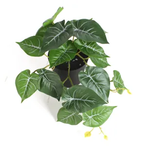 Top-down detailed view of artificial potted plant with white-veined green leaves decor