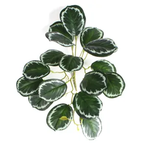 Close-up of 3D printed artificial watermelon leaves with vibrant green and white patterns.
