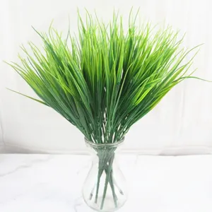 Detailed view of 7-prong artificial green water grass in a transparent glass vase