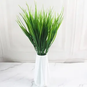Close-up view of 7-prong vibrant green artificial water grass arranged in a white vase.