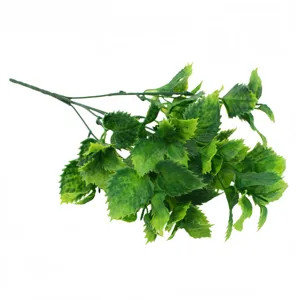 Artificial plant leaf detail shot, green plastic foliage accessory for home decor and walls.