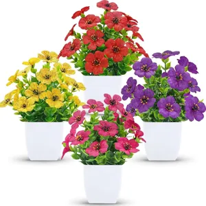 Detailed view of four colorful artificial potted plants in minimalist white plastic pots