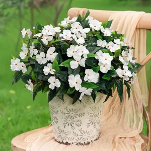 Beautiful white artificial impatiens flowers in a decorative pot for outdoor garden decor