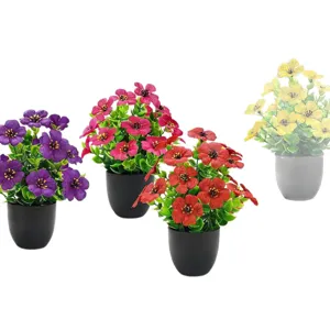 Set of colorful artificial small potted plants with purple red pink and yellow flowers
