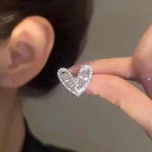 Macro detail of a sparkling silver heart-shaped CZ ear cuff for non-pierced ears.
