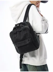 Black washed denim small backpack shown on model for size and style reference