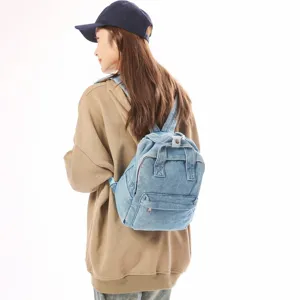Vintage-style women's small denim backpack in light blue wash for casual daily travel