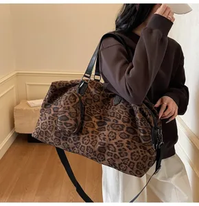 Dettaglio della borsa da viaggio leopardata, grande shopper e tracolla da donna.
