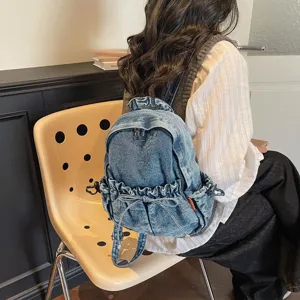 Petit sac à dos en denim pour femme, rucksack vintage décontracté avec cordon et nœud pour voyage.