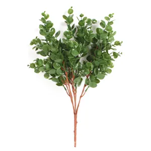Artificial eucalyptus branch detail, green foliage and brown stem, close-up view.