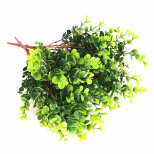Detailed macro view of artificial eucalyptus green leaves and brown stems