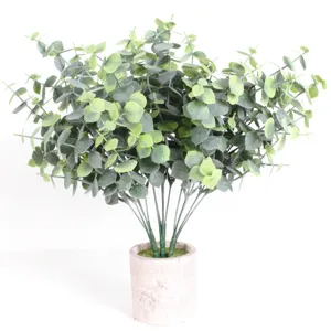 Detailed close-up of artificial eucalyptus plant with lush green leaves in a textured pot