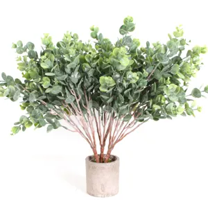 Artificial frosted eucalyptus plant detail view, realistic green money leaf bonsai decor.