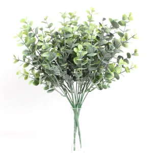 Detailed view of artificial green eucalyptus leaves in a clear glass vase for decor