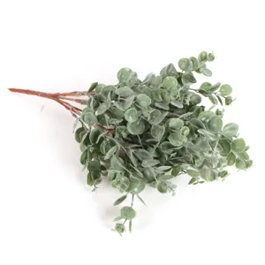 Close up detail of artificial frosted eucalyptus leaves branch, realistic green foliage.