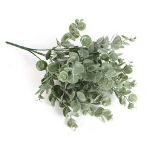 Artificial eucalyptus branch with frosted leaves, fake green plant for home floral decor.