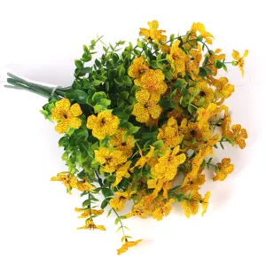 Detailed macro shot of artificial yellow eucalyptus flowers with green plastic leaves