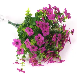 Decorative realistic purple artificial violet flowers with eucalyptus foliage detail