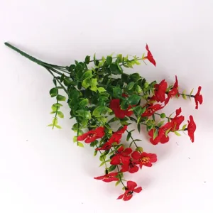 Close-up view of 7-prong artificial red violet flowers with green eucalyptus leaves