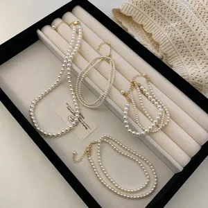 Elegant white pearl necklaces and bracelets set in a professional jewelry display tray