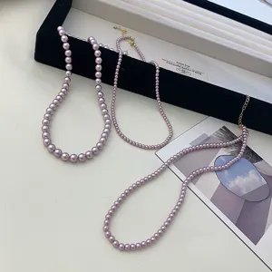 Elegant purple pearl necklaces in various bead sizes with gold clasp details