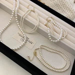 Detailed view of elegant white pearl necklaces and bracelets in a jewelry tray.
