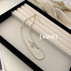 Detailed view of an elegant 4mm white pearl necklace displayed on a jewelry tray