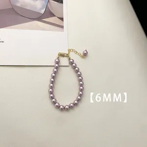Detailed view of 6mm purple pearl necklace with a delicate golden clasp and extension chain.
