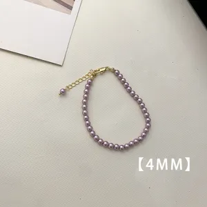 Detail view of a 4mm small purple pearl bracelet with adjustable gold clasp