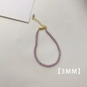 Elegant detail showing 3mm minimalist purple pearl necklace with golden extender chain