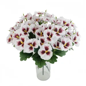Artificial pansy flowers bouquet detail in clear glass vase, realistic silk floral decor.