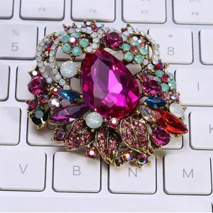 Macro detail of a vintage Bohemian style brooch with large pink waterdrop crystals