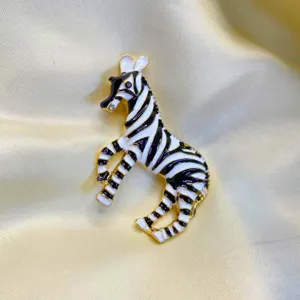 Close-up of vintage handmade enamel zebra brooch with elegant black and white stripes