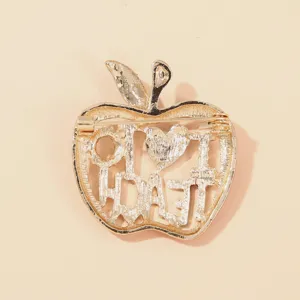 Detail view showing the pin mechanism on the back of the apple-shaped teacher gift brooch