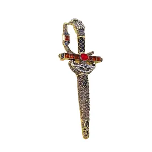 Close-up of vintage rhinestone sword brooch with ruby accent