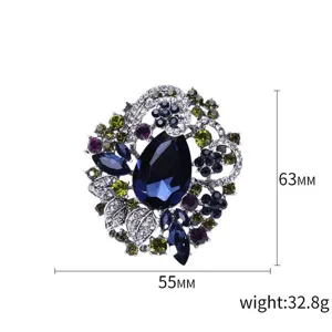 Luxurious Bohemian floral brooch featuring large blue crystal teardrop and stones