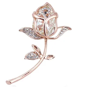 Close-up of elegant rose gold flower brooch featuring crystal petals and rhinestones