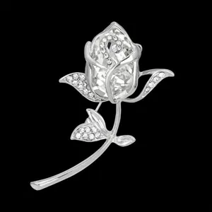 Macro detail of elegant silver-colored rose brooch with sparkling clear crystals