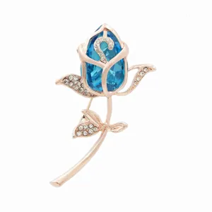 Macro view of an elegant tulip brooch with blue crystal and rose gold rhinestones