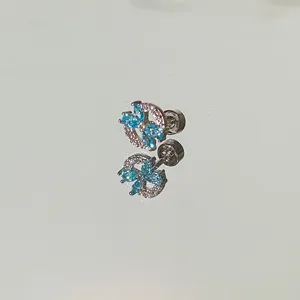 Detailed macro shot of a blue butterfly stud earring with sparkling marquise stones