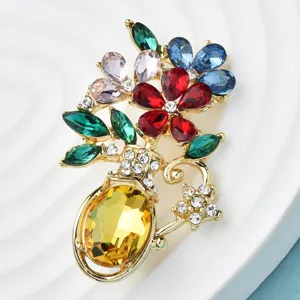 Close-up of elegant flower vase brooch with colorful rhinestones and gold plating