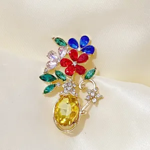 Detailed view of an elegant flower vase brooch with colorful crystal gemstones.