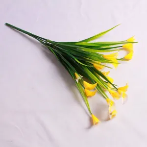 Detailed view of artificial yellow calla lilies with 5 prongs and green leaves for decor
