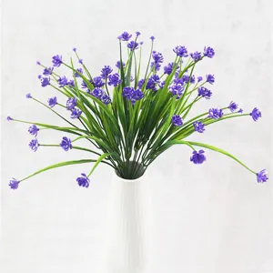 Lifelike artificial purple small peony flowers with green spring grass stems in a bouquet