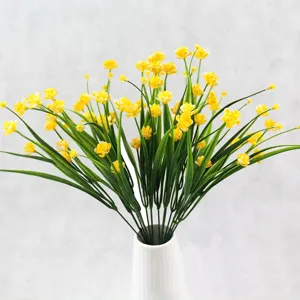 Lifelike yellow artificial small peonies in a white ceramic vase for home decoration